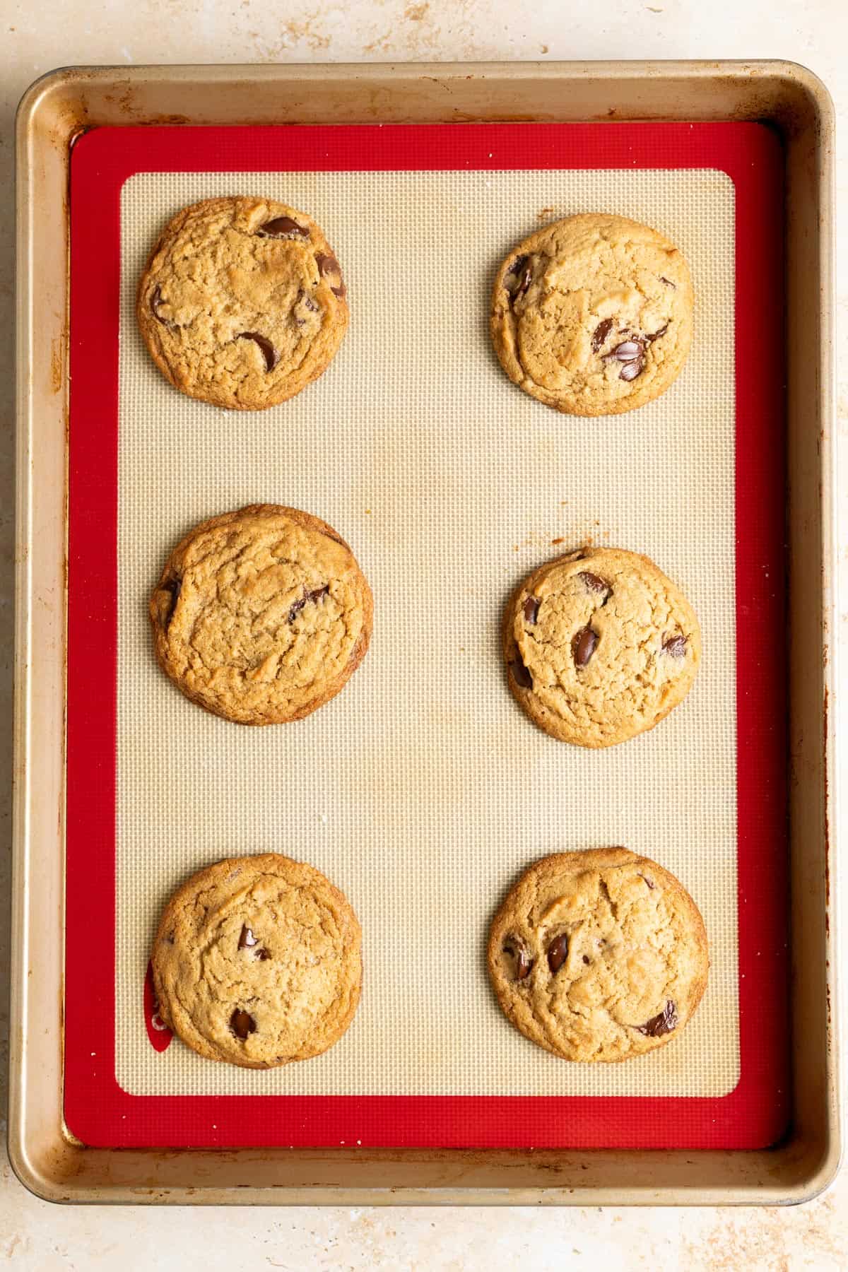 Baked miso sourdough discard chocolate chip cookies on a baking sheet.