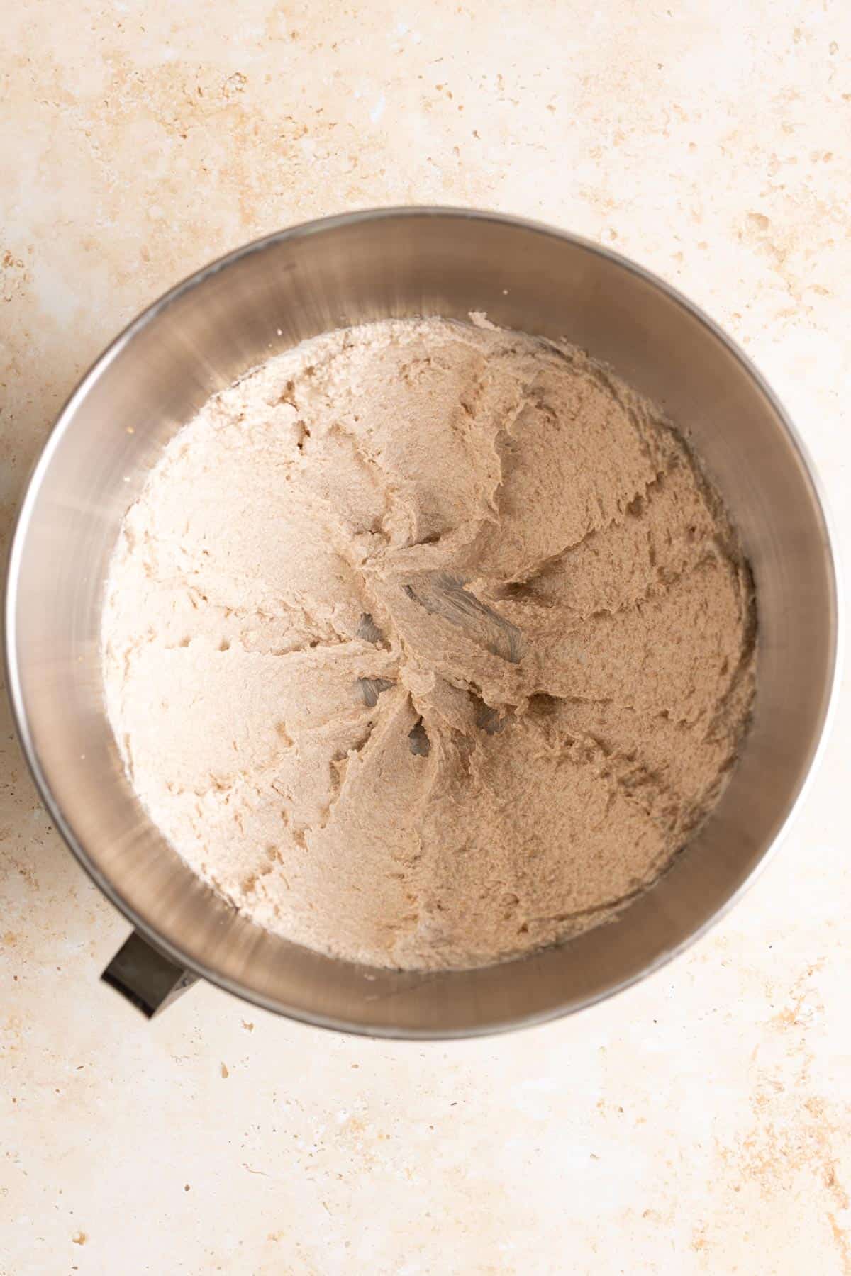 Cream brown butter and sugar in a metal mixing bowl.