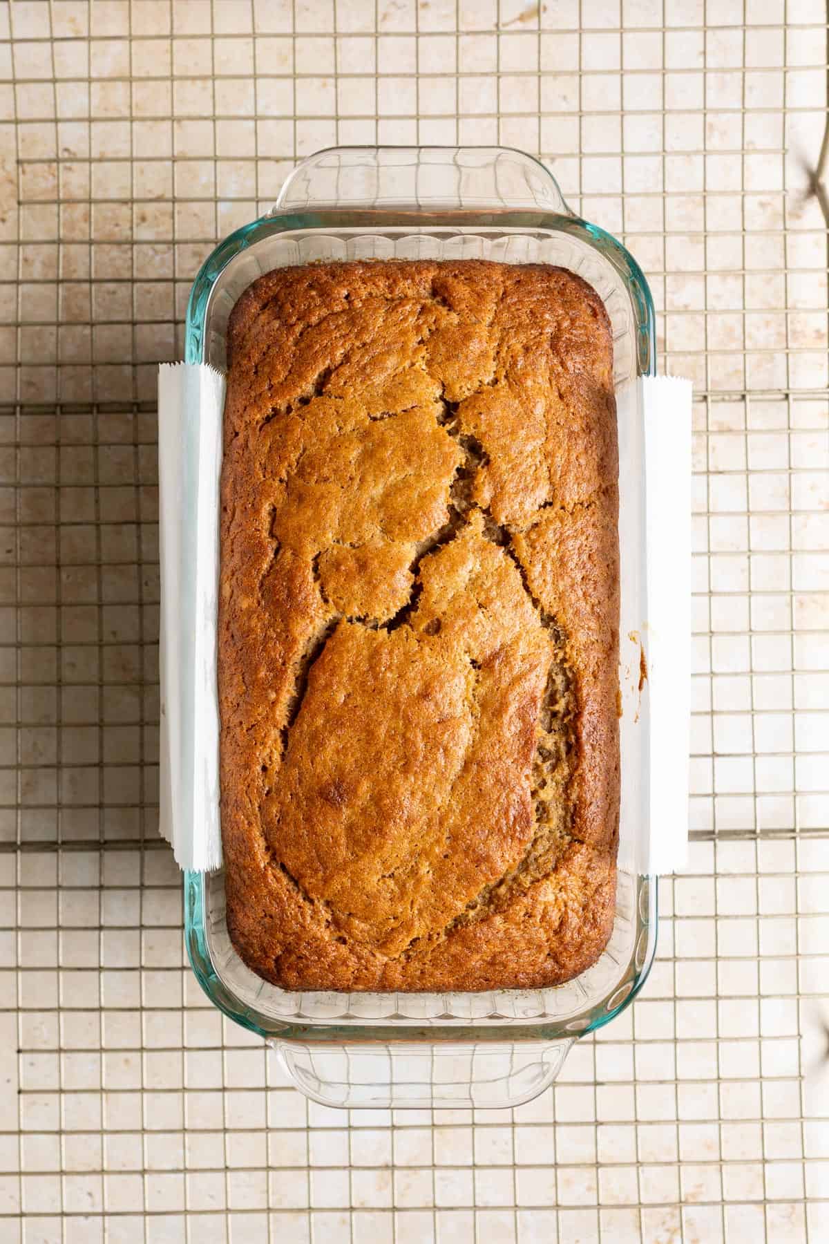 Baked sourdough discard banana bread in a glass loaf pan.