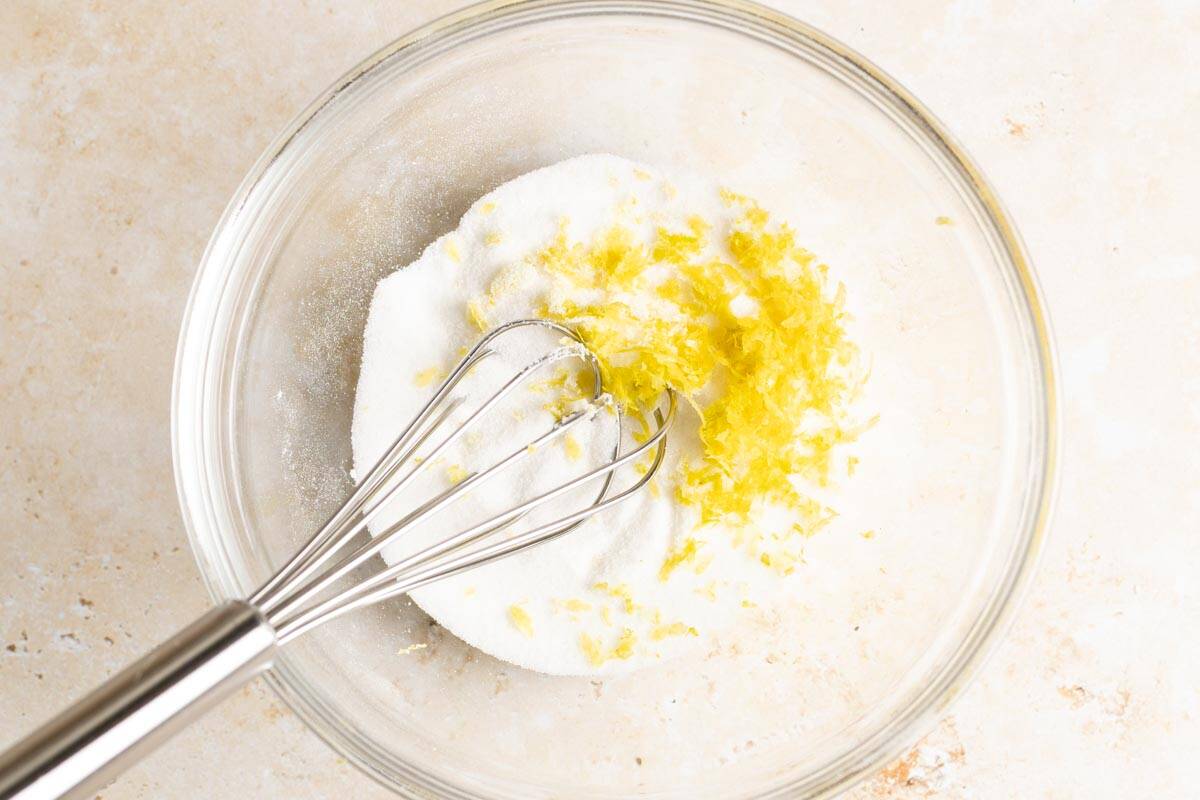 Lemon zest and sugar in a glass bowl.
