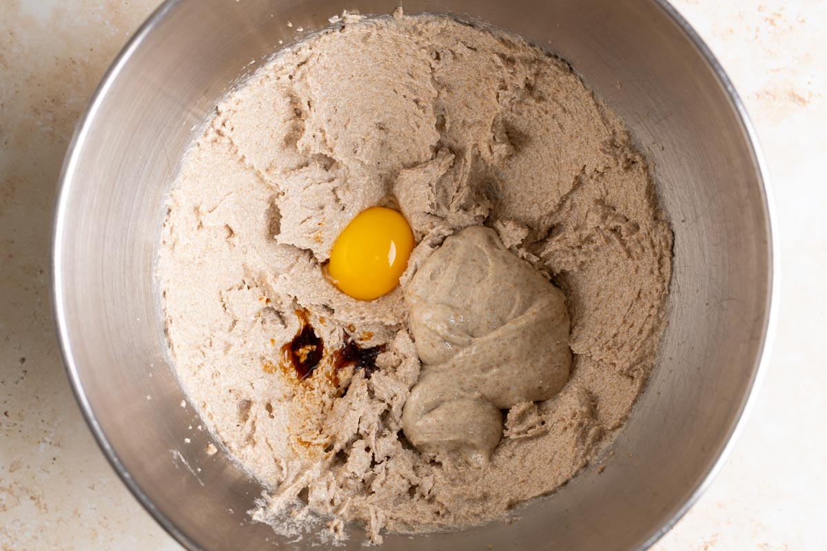Add egg yolk, sourdough discard, and vanilla to creamed butter.