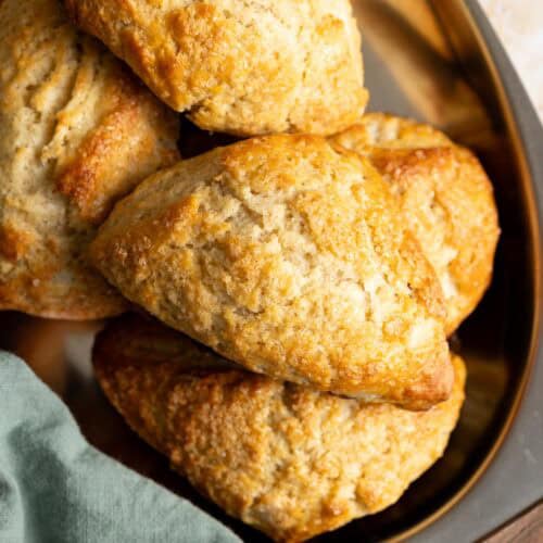 Golden sourdough scones on a metal tray.