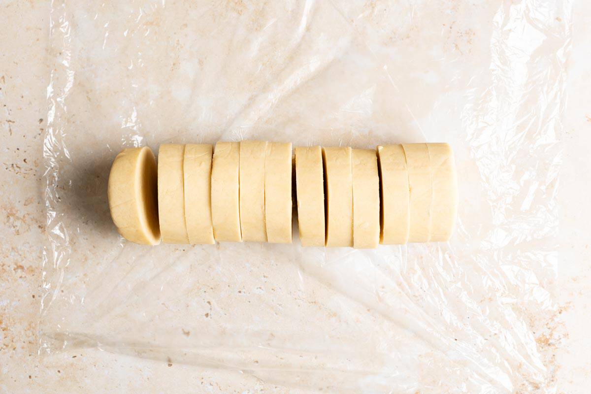 Sliced shortbread cookie dough log.