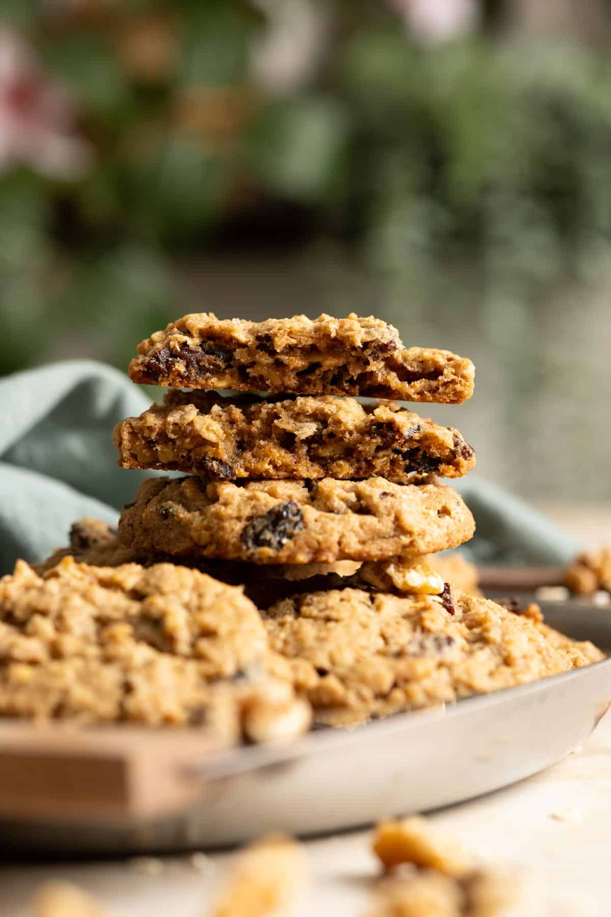2 half pieces of sourdough oatmeal raisin cookies stacked on top a full cookie, showing their interior texture.
