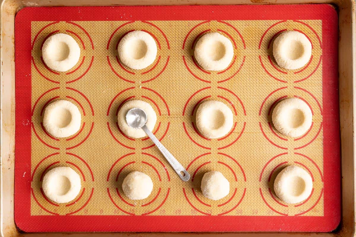 Create thumbprints using a measuring teaspoon.