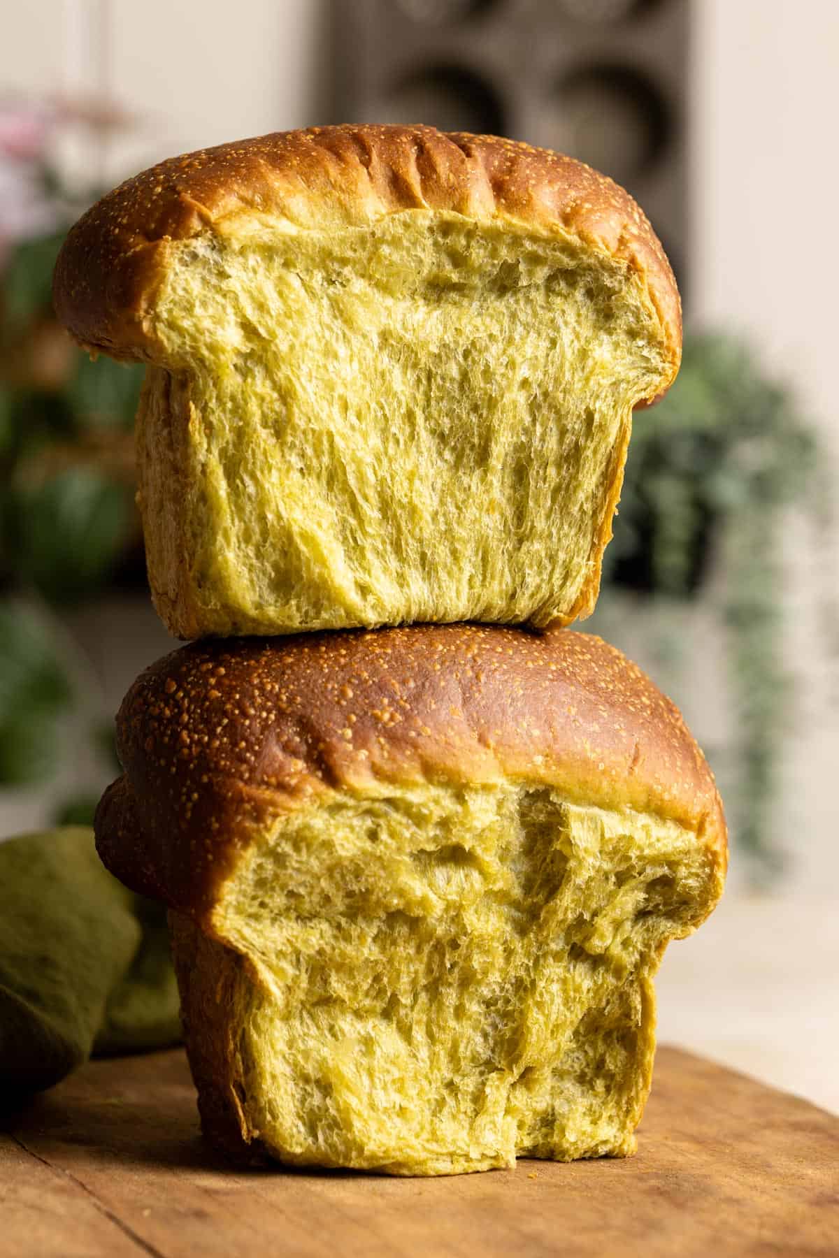A stack of 2 matcha milk bread loaves.