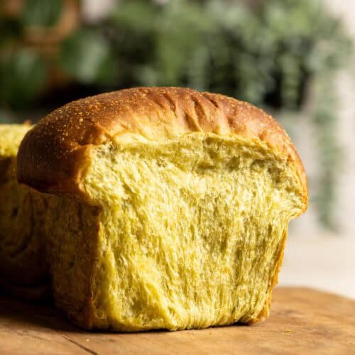 A section of sourdough matcha milk bread on a wooden board.