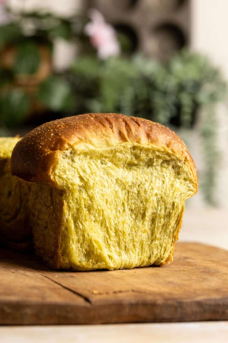 A section of sourdough matcha milk bread on a wooden board.