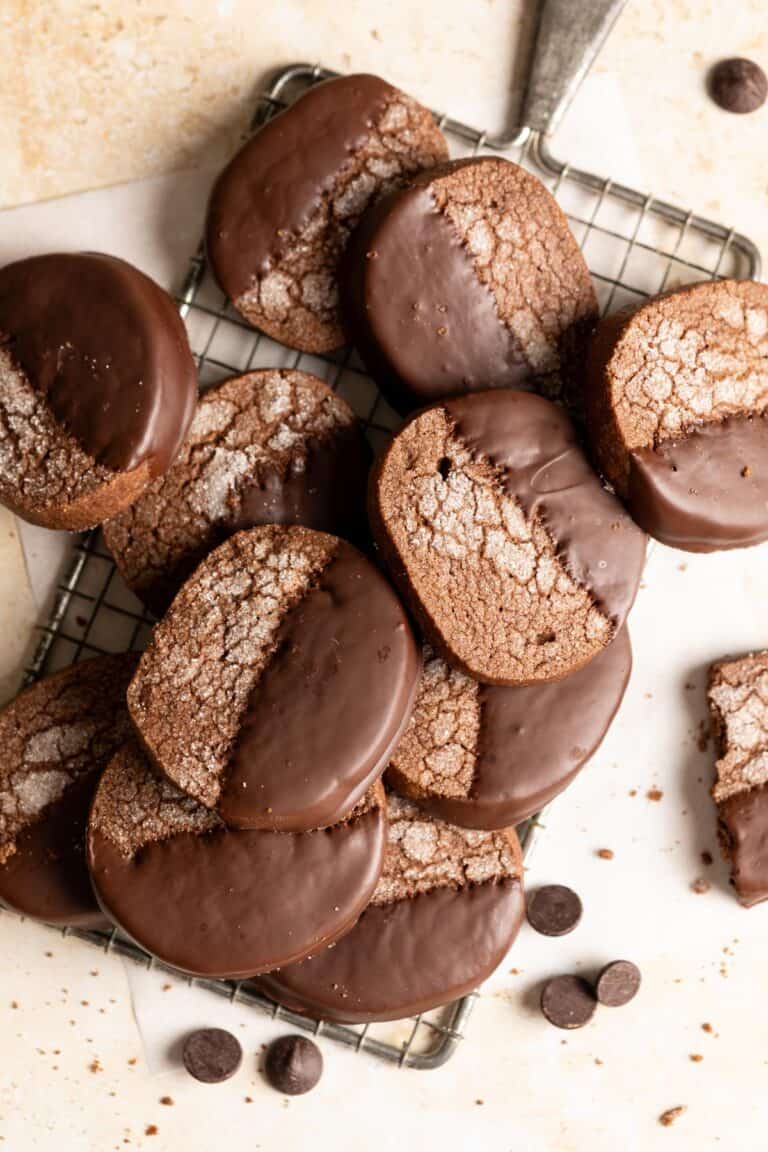 Chocolate covered sourdough chocolate shortbread cookies laying on top of each other.