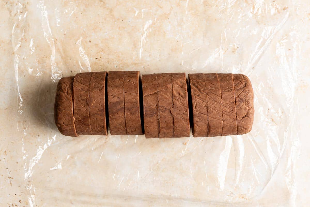 Sliced chocolate shortbread dough log.