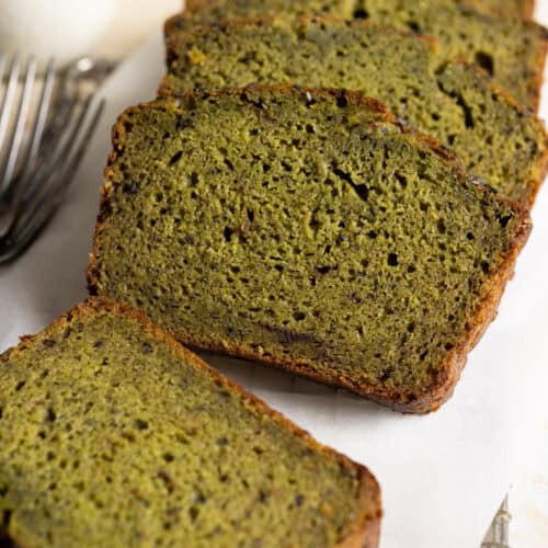 Slices of sourdough matcha banana bread on a piece of parchment paper.
