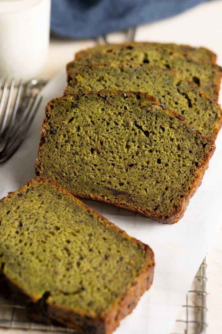 Slices of sourdough matcha banana bread on a piece of parchment paper.
