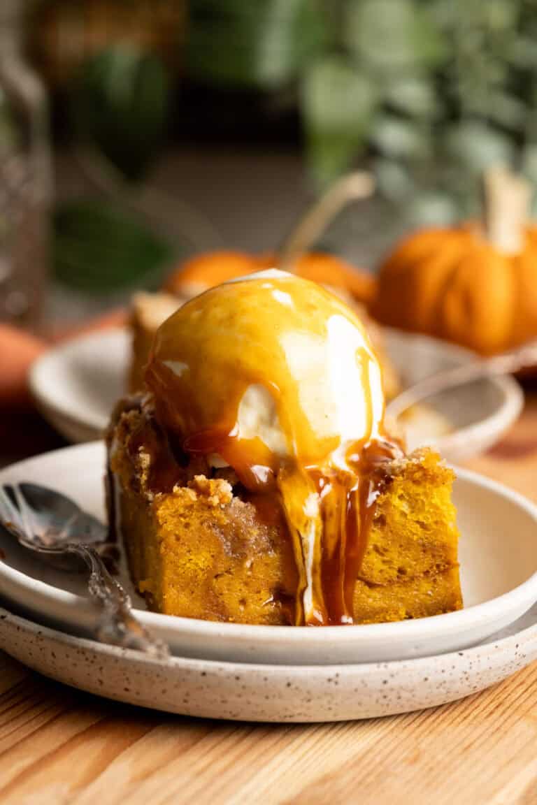 Pumpkin bread pudding with vanilla ice cream and miso caramel running down the side.