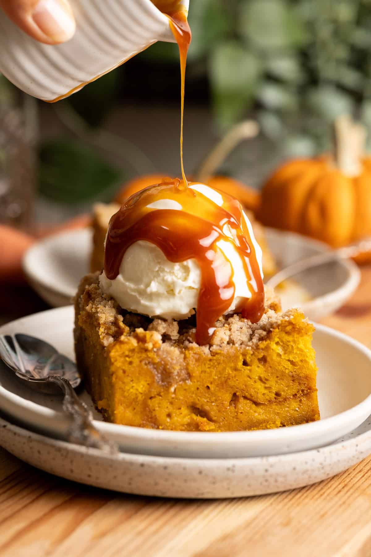 Miso caramel drizzling over the ice cream on top of pumpkin bread pudding.